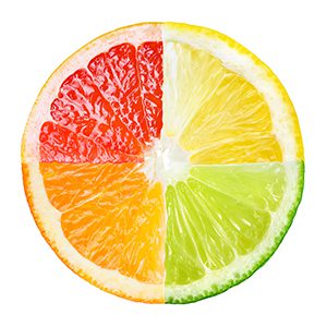 Citrus fruit cut in fourths and each section is a different bright color.